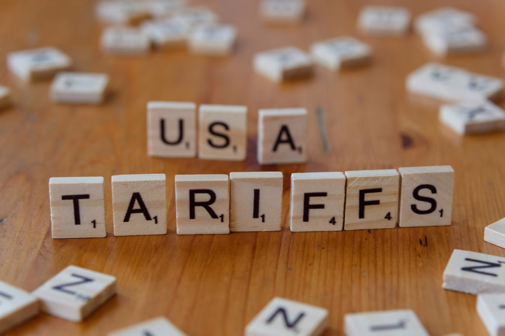 US-India Tariff News: The Impact on IT Outsourcing, H1B Visas, and Remote Work 2 usa tariffs concept with scrabble tiles